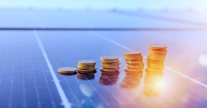 solar panels with stacks of coins on it