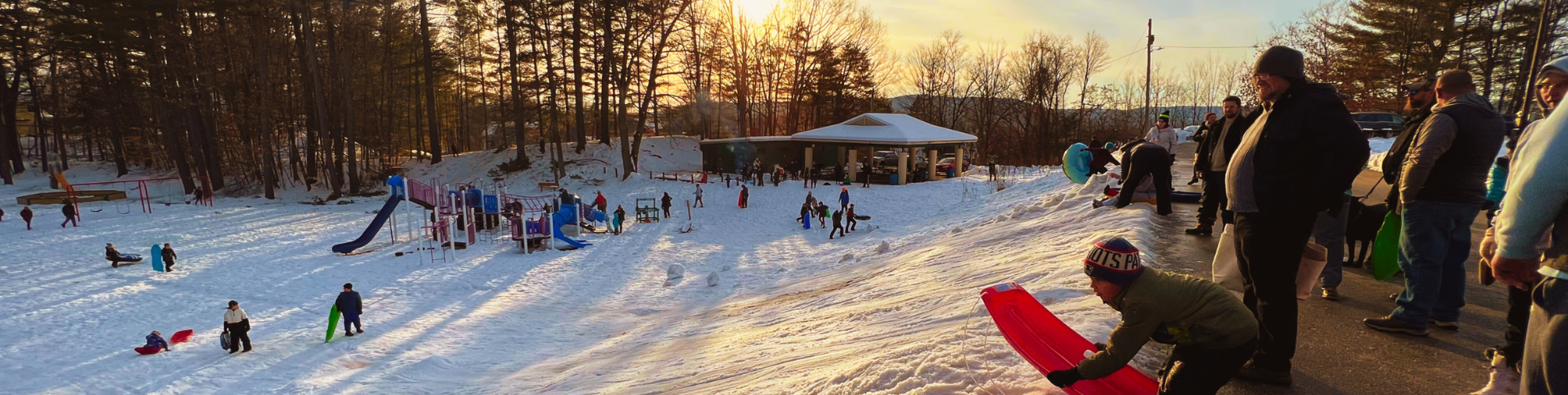 photo of community members sledding