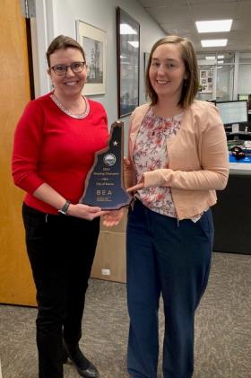 City Manager Elizabeth Dragon and Senior Planner Mari Brunner holding a plaque