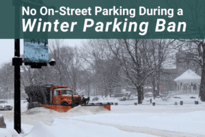 a large truck plowing snow on a downtown street