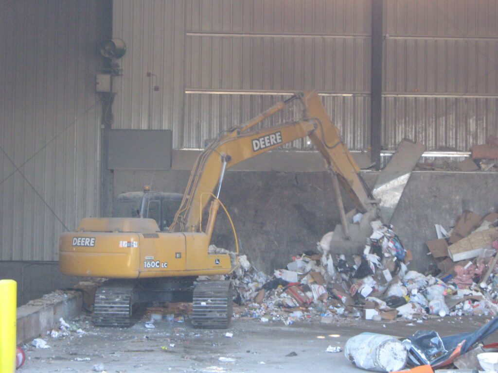 trash being moved in transfer station