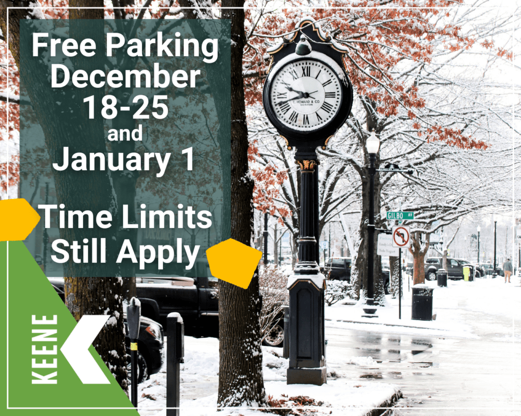 Snowy downtown Keene with vehicles parked along Main Street