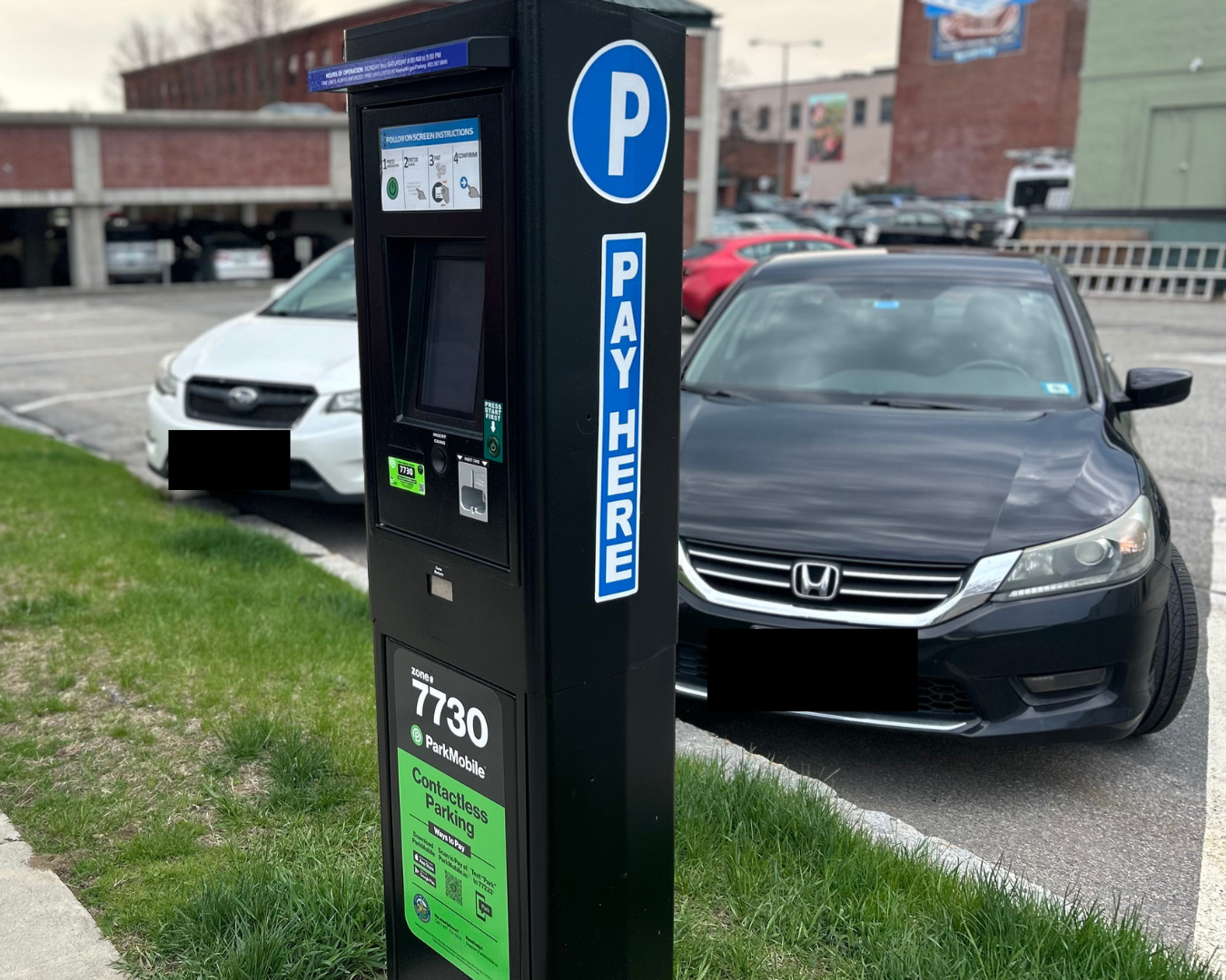 Cars parked in front of parking kiosk
