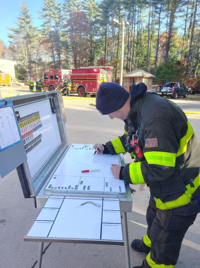 Firefighter draws on a whiteboard