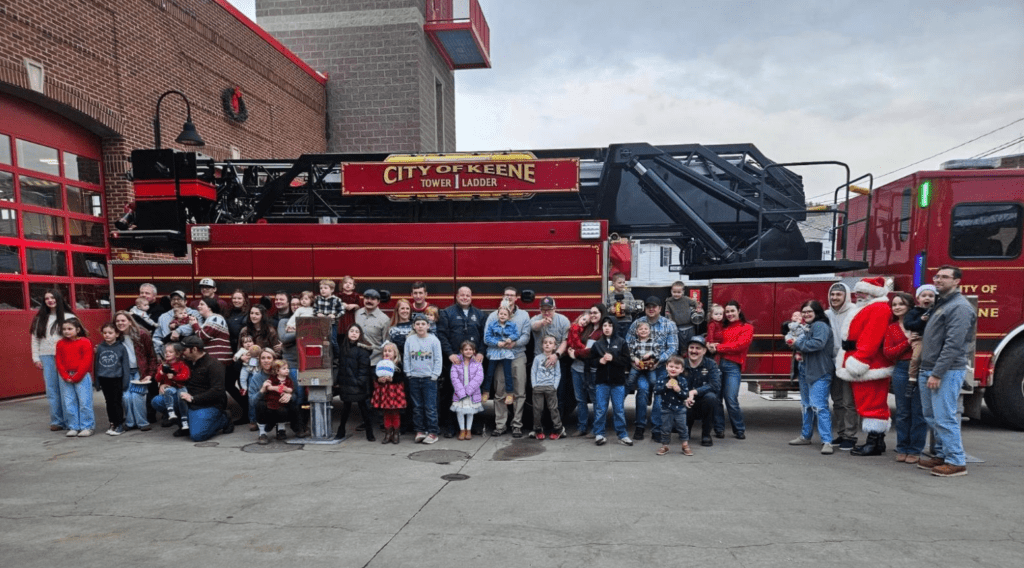 KFD crew and their families pose in front of a fire engine