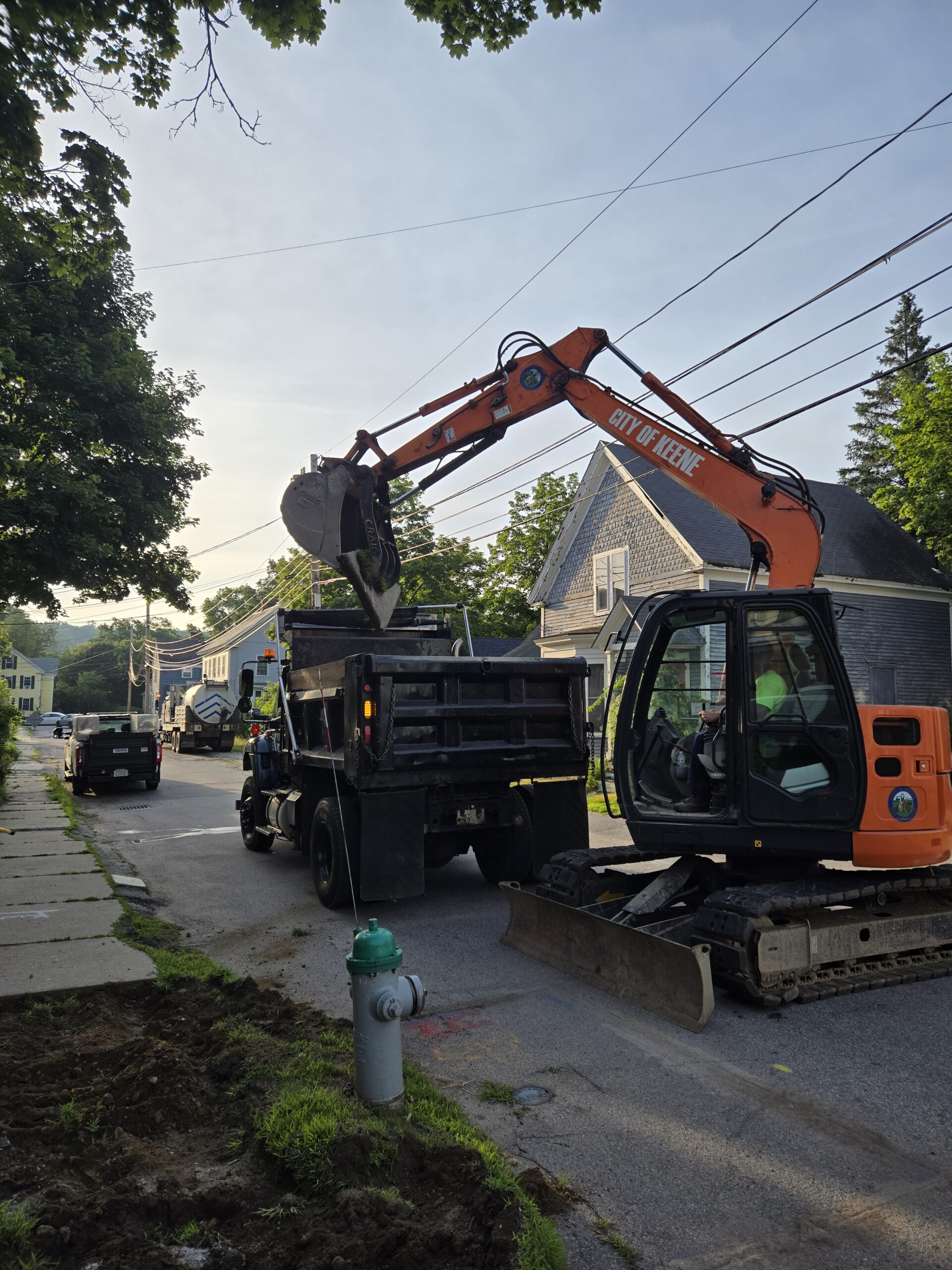 excavator loading material into the back of a dump truck